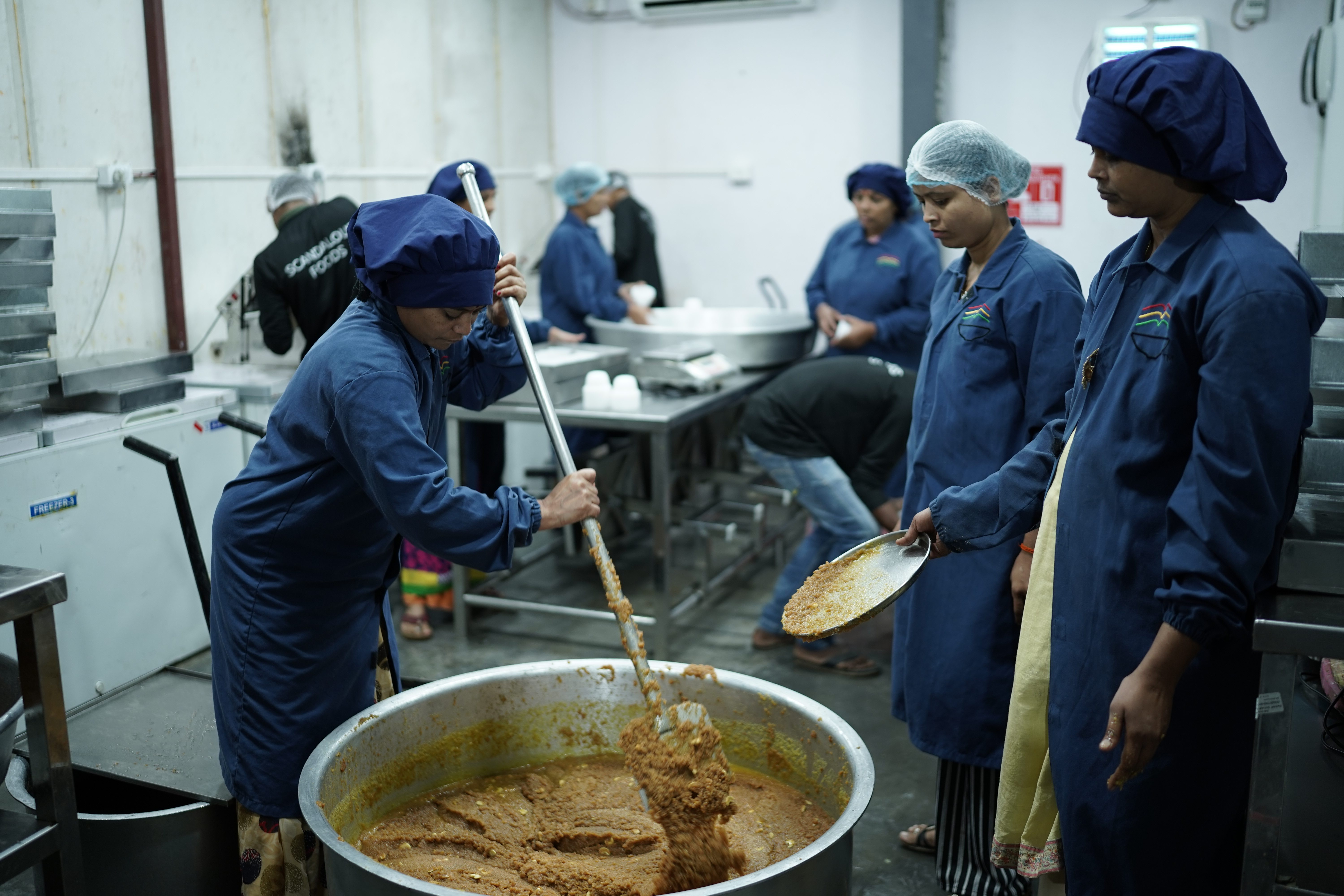 Professional team preparing traditional mithai in hygienic conditions