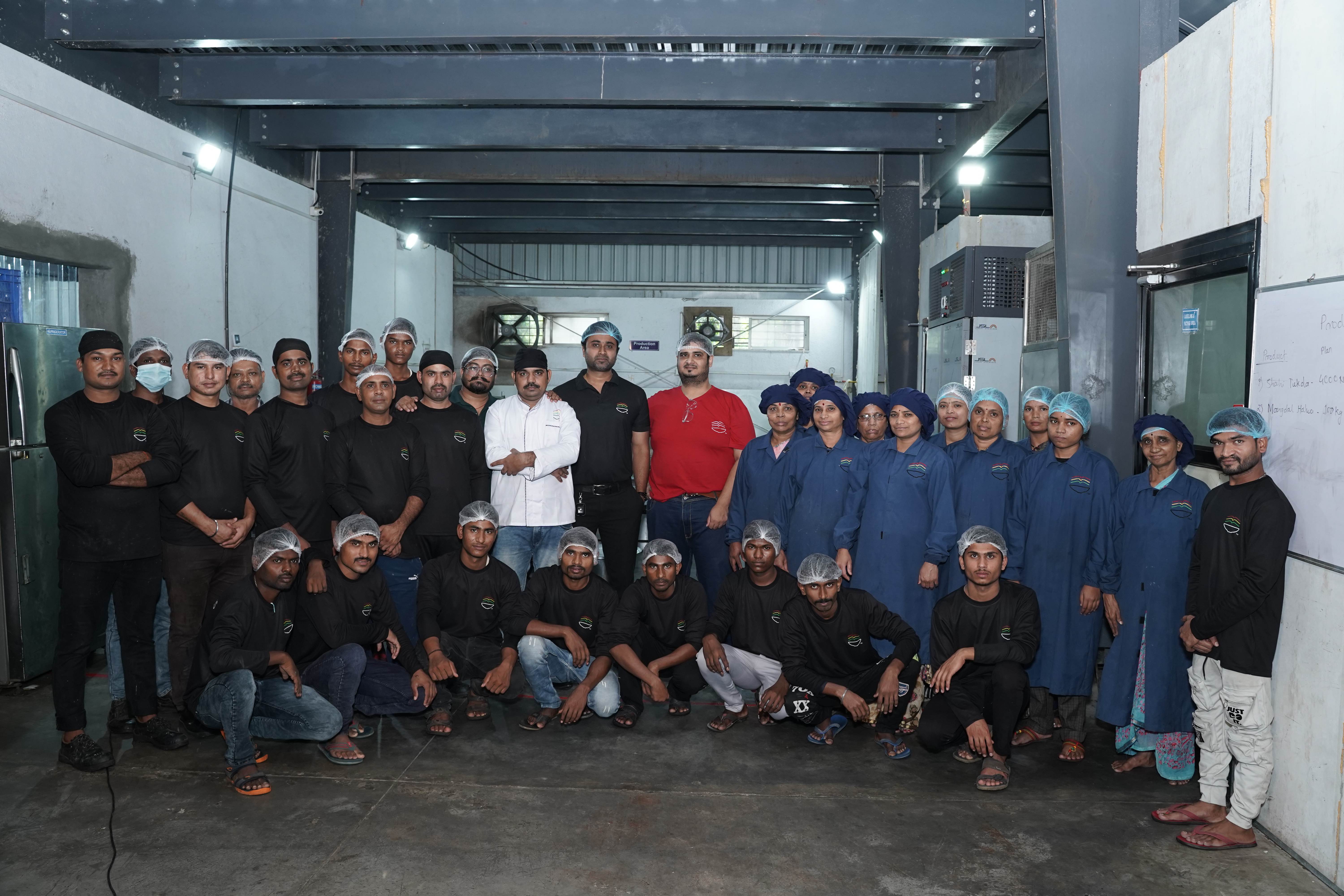 Complete Scandalous Foods production team in professional uniforms